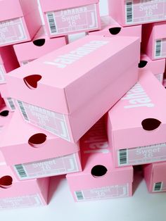 many pink boxes stacked on top of each other