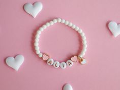 Kids Bracelet with Heart Charms and Natural White Stone Beads Adorn your child's wrist with our beautiful Kids Bracelet, featuring delicate colourful heart charms and natural white stone beads. This lovely accessory adds a touch of elegance and charm to any outfit, making it perfect for everyday wear or special occasions. Key Features: Heart Charms: Cute heart charms that symbolize love and friendship. Natural White Stone Beads: Elegant and durable, these beads add a touch of sophistication. The Cute Heart Bracelet With Round Beads For Valentine's Day, Valentine's Day Playful Beaded Jewelry, White Heart-shaped Jewelry For Birthday, Playful Heart-shaped Letter Beads Bracelet, Cute Heart Beads Charm Bracelet For Valentine's Day, Heart-shaped Charm Bracelet For Birthday Gift, Birthday Heart Charm Bracelet, Pink Heart-shaped Name Bracelet For Valentine's Day, Heart-shaped Letter Beads Jewelry For Mother's Day