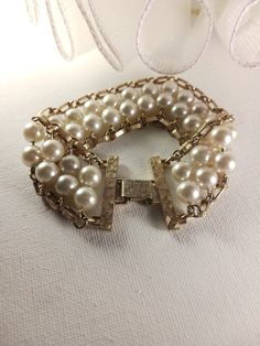 This vintage Pearl Flattery bracelet features faux pearl and gold tone chain link with a snap lock clasp. Sarah Coventry signed. This bracelet is in good vintage condition. Sarah Coventry signed Faux Pearl and Gold Tone Chain Link Bracelet, Vintage Wedding Jewelry, Bridal Reflections, SFV138   <-- BACK to my shop and please remember to admire my shop for further updates: https://www.etsy.com/shop/silverfeathervintage Thank you for your interest in Silver Feather Vintage! * Please carefully revie Elegant Wedding Jewelry With Clasp Detail, Elegant Wedding Bracelets With Clasp, Elegant Wedding Bracelet With Clasp, Gold Pearl Bracelet With Chain, Elegant Gold-tone Jewelry With Box Clasp, Elegant Gold-tone Bracelets With Clasp, Elegant Evening Jewelry With Gold Clasp, Metal Chain Bracelet With Gold Clasp For Formal Occasions, Formal Metal Chain Bracelet With Gold Clasp