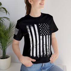 American Flag (Distressed Style) T-Shirt with Flag on Sleeve, Patriotic Shirt, American Flag T Shirt, Great Patriotic Gift This classic Bella & Canvas unisex jersey short sleeve tee fits like a well-loved favorite. Soft cotton and quality print make users fall in love with it over and over again. These t-shirts have-ribbed knit collars to bolster shaping. The shoulders have taping for better fit over time. Dual side seams hold the garment's shape for longer.  ❤️Bella & Canvas T-Shirt Features❤️ Casual Black Shirt With American Flag Print, Basic Distressed Cotton T-shirt, Casual American Flag Print T-shirt With Relaxed Fit, Casual Relaxed Fit T-shirt With American Flag Print, Casual American Flag Print T-shirt, Relaxed Fit, Casual American Flag Print Relaxed Fit T-shirt, Distressed Short Sleeve Basic T-shirt, Distressed Basic Short Sleeve T-shirt, American Flag Crew Neck Shirt With Relaxed Fit