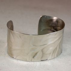 "This is a sterling silver cuff bracelet with a leaf textured pattern pressed in the metal. The cuff bracelet measures 1-1/4\" x 6\", it is slightly concave to give comfort to your wrist. The bracelet is textured, then the corners rounded, and concaved, and then polished to a high finish. This bracelet is gorgeous and fun to wear. You will love it :) Item comes gift boxed, please allow up to 1-2 weeks to complete order. Check out more bracelets: https://www.etsy.com/shop/kellymaekreations?section_id=16382186&ref=shopsection_leftnav_4 Check out more items: http://www.etsy.com/shop/kellymaekreations Please contact me with any questions. I appreciate your business! Copyright - Kelly Mae Kreations" Elk Ivory Jewelry, Pmc Jewelry, Bracelet Wide, Metal Cuff Bracelet, Leaf Texture, Cuff Jewelry, Sterling Silver Cuff Bracelet, Wide Cuff, Jewelry Bracelet