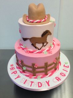 a pink and white cake with a horse on it