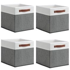 four grey and white storage boxes with leather handles