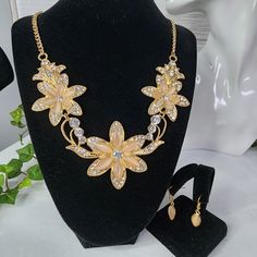 So Pretty And Festive Is This Set Vintage Vibes 21" Gold Tone Chain Flowers Have Moonstone? Glass ? Stones And Crystal Glass Zirconia Matching Oval Drop Hook Style Earrings New @449b Casual Dressy Work Office Wedding Bridal Holiday Festive Glam Gala Elegant Party Flower-shaped Gold Jewelry Sets, Elegant Gold Metal Flower Necklace, Gold Metal Flower Necklace For Wedding, Gold Flower-shaped Costume Jewelry Necklace, Gold Crystal Flower Necklace, Gold Flower-shaped Costume Necklace, Gold Floral Crystal Necklace, Gold Flower Crystal Necklace, Gold Flower Costume Jewelry Necklace