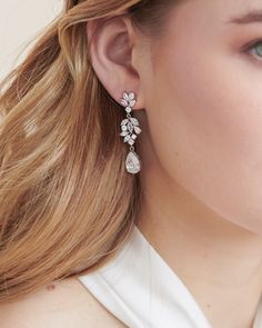 Classic structure meets modern floral in our Helena CZ Dangle Earrings. Designed with clusters of marquise, round & teardrop shaped CZs that descend into a pear shaped drop. Cubic zirconia Measures .5" x 1.75" long Hypoallergenic, lead-free & nickel-free Style #4394 Diamond Teardrop Chandelier Earrings, Teardrop Diamond Chandelier Earrings With Sparkling Stones, Teardrop Diamond Bridal Earrings With Sparkling Stones, Diamond Teardrop Chandelier Earrings With Sparkling Stones, Dazzling Diamond White Teardrop Chandelier Earrings, Teardrop Chandelier Earrings With Diamond Accents, White Gold Teardrop Cubic Zirconia Chandelier Earrings, Sparkling Diamond Teardrop Bridal Earrings, Diamond White Teardrop Chandelier Earrings With Diamond Accents