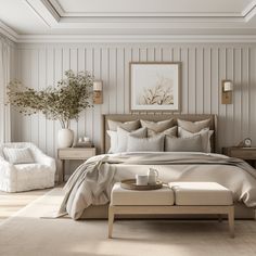 a large bed sitting in a bedroom next to a white chair and table with a vase on it