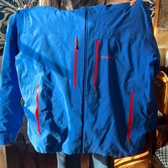 Incredible Jacket! Worn For One Season. Incredibly Warm With Optimal Storage And Breathability. A Few Small Stains As Pictured, Easily Removable With A Wash. Men’s Ski Jacket In Excellent Condition. 100% Nylon With 100% Polyester Lining And 85% Goose Down Insulation. Durable Waterproof, Wind Proof And Breathable. Zippered Compartments Under The Arms, Inside The Body Of The Jacket By Stomach Holds A Mesh Pouch. Two Way Adjustable Fixed Hood With A Laminated Visor. Blue Long Sleeve Skiing Jacket, Blue Long Sleeve Outerwear For Skiing, Blue Hooded Outerwear For Snowboarding, Waterproof Patagonia Outerwear, Blue Patagonia Outerwear With Pockets, Functional Blue Outerwear For Snowboarding, Blue Functional Snowboarding Outerwear, Functional Blue Snowboarding Outerwear, Patagonia Long Sleeve Windbreaker For Hiking