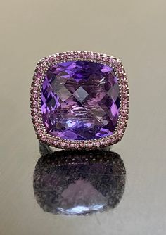 DeKara Designs Collection Entirely Handmade Beautiful Huge Cushion Cut Checkerboard Amethyst Halo Purple Tourmaline Ring. Metal- 18K White Gold, .750.  21 Grams. Stones- Genuine Cushion Cut Checkerboard Amethyst 30 Carats, 132 Round Purple Tourmalines 2.60 Carats. Measurements of Amethyst Approximately 20MM x 20MM. Amazing One of a Kind Entirely Handmade Checkerboard Cut Cushion Amethyst Halo Purple Tourmaline Engagement Ring.  This ring is entirely handmade in 18K White Gold, featuring a dazzli Luxury Amethyst Ring With Cushion Cut Center Stone, Luxury Classic Cushion Cut Amethyst Ring, Luxury Amethyst Gemstones With Accent Stones, Luxury Purple Multi-stone Rings, Luxury Pink Amethyst Gemstone Ring, Luxury Pink Amethyst Ring With Accent Stones, Formal Pink Amethyst Ring With Gemstone Accents, Purple Multi-stone Amethyst Ring In Fine Jewelry Style, Luxury Purple Amethyst Ring With Center Stone