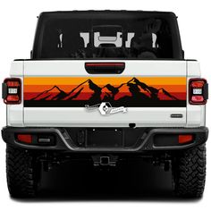 the back end of a white truck with an orange and yellow sunset painted on it