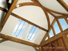 the inside of a building with wooden beams and windows