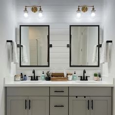 a bathroom with double sinks and two mirrors