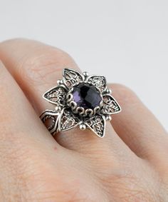 This everyday use, lace embroidery daisy flower 925 sterling silver filigree art cocktail ring has Amethyst / Black Rutile gemstone.  This stunning sterling silver ring is a modern take on the classic crown. The ring face is 0.85 of an inch (21.5 mm) and comes with a amethyst / black rutile gemstone that's 8 mm long and has been faceted to a round-cut to enhance the stone's beauty. This versatile piece looks great with both day and evening attire and features a smooth oxidized finish, ensuring lasting beauty in any lighting. We love its versatility since it lends itself to different ensembles on any occasion. Whether you're looking for a subtle accent or something to really take center stage, you'll fall in love with this stylish women flower cocktail ring. The cocktail ring comes with a v Elegant Sterling Silver Flower Ring With Birthstone, Elegant Flower Ring Gift, Stamped 925, Silver Flower Ring With Birthstone, Elegant Silver Flower Ring With Birthstone, Elegant Purple Gemstone Flower Ring, Purple Intricate Design Jewelry For Gift, Silver Filigree Flower Ring As Gift, Silver Amethyst Ring With Intricate Design For Gift, Silver Filigree Flower Ring Gift