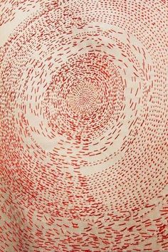 a red and white rug with circles on it