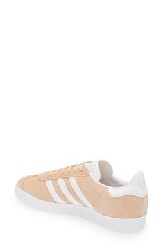 Initially designed as a training shoe for top athletes in 1991, adidas' iconic Gazelle sneaker has been refreshed with a sleek, narrower silhouette but retains the classic contrasting 3-Stripes and heel tab of the original, and is presented in throwback archival hues. Lace-up style Cushioned footbed Removable insole Leather or leather and synthetic upper/textile and synthetic or synthetic lining/synthetic sole Imported BP. Shoes Adidas Low-top Skate Shoes With Contrast Sole, Adidas Synthetic Skate Shoes With Gum Sole, Adidas Sneakers With Gum Sole, White Sole Sneakers With Gum Sole, Athleisure Lace-up Sneakers For Skateboarding, Adidas Urban Sneakers With Gum Sole, Adidas Gazelle Sneaker, Down To Earth, Adidas Samba Sneakers