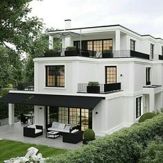 a large white house with black balconies