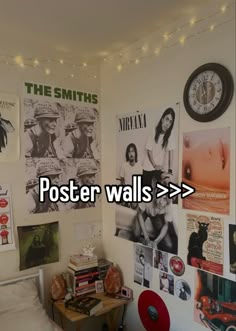 a bedroom with posters on the wall and a clock above it that reads poster walls > > >