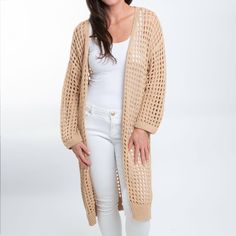 Beat the chill in style with the Enya Long Crochet Cardigan. Featuring a trendy neutral sepia tone with an open crochet detail, this cardigan is easy to wear and certain to become your spring go-to. This long sleeve sweater is perfect for your Spring and Summer wardrobe, throw over your favorite top with a pair of leggings or skinny jeans with some sandals and necklace for a classic look! This top is a light weight sweater, it will give you enough warmth and comfort in a cool day without looking Trendy Open Knit Outerwear, Lightweight Cardigan For Layering In Fall, Lightweight Cardigan For Fall Layering, Lightweight Fall Cardigan For Layering, Spring Open Knit Cardigan, Lightweight Long Sleeve Winter Cardigan, Spring Knitted Cardigan For Layering, Lightweight Casual Cardigan For Fall, Lightweight Long Sleeve Outerwear For Spring