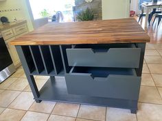 a kitchen island made out of drawers in the middle of a tile flooring area