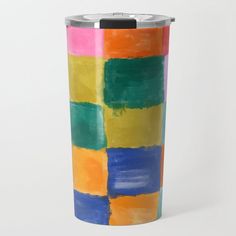 a multicolored tumbler cup sitting on top of a white table