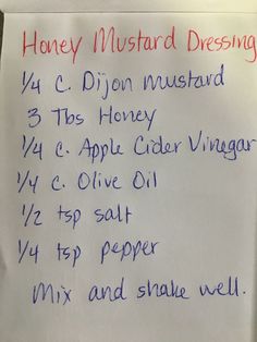 a sign posted on the side of a white board that says honey mustard dressings