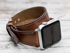 "Genuine leather brown Apple Watch wrap, 42mm, 38mm, 40mm, 44mm for series 1-6 & SE. Size: This strap is medium size and fits 150-190 mm (5.9\"-7.4\") wrists. Seven different color options for adapters (Silver, Black, Space Gray, Rose Gold, Yellow Gold, Red and Blue). Adapter color and buckle color will be same. Shipping takes usually 3-4 business days (via USPS First Class-Free), 2 business days (via FedEx 2Day) and 1 business day (via FedEx Overnight). To Europe: 1-2 business days via TNT Brown Leather Strap Apple Watch Band, Modern Brown Watches With Bracelet Strap, Classic Brown Rectangular Apple Watch Band, Modern Brown Rectangular Apple Watch Band, Modern Brown Apple Watch Band For Everyday Use, Brown Bracelet Strap Watch Bands, Classic Brown Apple Watch Band For Everyday Use, Modern Brown Apple Watch Band As Gift, Modern Brown Leather Apple Watch Band