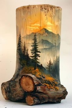 a piece of wood that has been painted with trees and mountains in the back ground