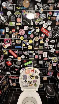 a white toilet covered in lots of stickers