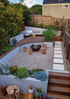 an outdoor patio area with wooden steps and plants on the ground, including succulents