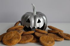 a pumpkin with its mouth open surrounded by crackers