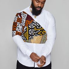 Back in stock! Men's white dress shirt. 100% cotton with African print panels across arm and chest. This classic and timeless dress shirt is crafted from breathable 100% cotton, with stylish African print panels that bring a unique touch to any outfit. Model is wearing size Large. White Long Sleeve Shirt With Patchwork, Fitted White Patchwork Shirt, African Men Fashion Shirts, Ankara Shirts For Men, Wedding Booth, Men African Fashion, Man Dress Design, Gents Shirts, Mens White Dress Shirt