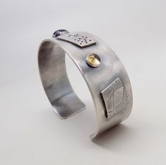 "Awesome sterling silver cuff bracelet. I formed the cuff from 18gage heavy sterling silver. A 8mm by 10 mm amethyst is at the center and 6mm garnet and 6mm citron gem stones at each side. The cuff is 3/4\"wide by 6 \" .All my jewelry come in a nice gift box." Modern Sterling Silver Cuff Bracelet Bangle, Modern Sterling Silver Cuff Jewelry, Silver Open Cuff Bracelet With Polished Finish, Anniversary Cuff Jewelry With Polished Finish, Anniversary Polished Cuff Jewelry, Sterling Silver Open Cuff Bangle For Gift, Sterling Silver Open Cuff Bangle As A Gift, Unique Polished Cuff Jewelry, Unique Sterling Silver Bangle With Gemstone