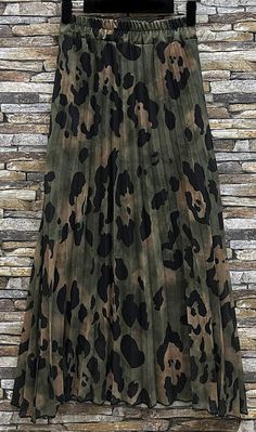 This eye-catching maxi skirt features an olive and black leopard print, bringing a wild flair to any outfit. The pleated design enhances flow and style, making it a versatile piece for both casual days and evening outings. Pair with a solid top for a balanced look. Polyester : 50%, Viscose : 45%, Elastane : 5% Made in Italy Petite Styling, Pleated Maxi Skirt, Black Leopard Print, Pleated Maxi, Black Leopard, Solid Tops, Kids Sleepwear, Trending Now, Maxi Skirt