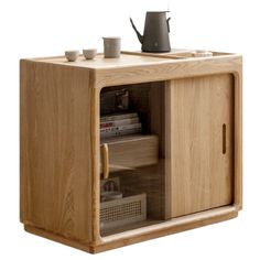 a wooden cabinet with two cups and a teapot on top, in front of a white background