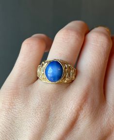 "* Vintage late 1900's - early 2000's solid 14 carat yellow gold dragon ring, set with a beautiful blue star sapphire.  * Stamped lightly on the inside of the band \"14K\", and \"AVC\" * Measurements:   Star Sapphire Cabochon- Approx. 12mm x 10mm x 5mm  * Weight- 9.6 grams Please view and inspect the photos closely, as they are considered part of the condition. I endeavor to fully disclose all condition information clearly, however, please note that what qualifies as excellent condition for historical jewelry / collectibles differs from modern and contemporary pieces. Minor age wear is typical and to be expected for antique and vintage jewelry. All items are unpolished and in their vintage condition, items can easily be polished up if so desired.     Enjoy,  Dev" Blue Cabochon Sapphire Ring In 14k Gold, Celestial Yellow Gold Signet Ring For Formal Occasions, Vintage Gold Sapphire Cabochon Ring, Gold Vintage Sapphire Cabochon Ring, Vintage Gold Sapphire Ring With Cabochon, Classic Blue Moonstone Ring For Formal Occasions, Heirloom 14k Gold Opal Ring Collectible, Blue Opal Ring In 14k Gold For Formal Occasions, Formal Blue Oval Cabochon Moonstone Ring