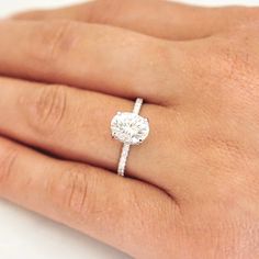 a woman's hand with a diamond ring on it