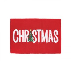 a red christmas door mat with the word christmas on it and a small green tree