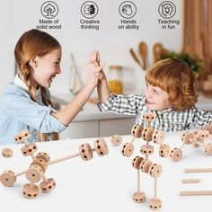 two children playing with wooden pegs on the table in front of an advertisement for wood toys