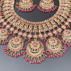 Featuring an intricate and beautifully carved heavy bridal jadau necklace set in 22ct gold. The necklace weighs 114.49 GMs including 13.79 GMs in hanging ruby emerald beads. The earrings weigh 34.81 GMs including 4.68 GMs in hanging ruby emerald beads. Price Breakup Summary Component Rupees % of Total 22k Gold 639,166 75.8% Stones & Beads 64,969 7.7% Making Charges 115,050 13.6% Taxes (GST) 24,576 3.0% Total 843,760 100.0% View Detailed Price Breakup Watch Video Here Watch Video Here2 Traditional Gold Emerald Necklace For Reception, Yellow Gold Meenakari Necklaces For Receptions, Traditional Kundan Emerald Necklace For Reception, Yellow Gold Necklaces With Meenakari For Reception, Meenakari Yellow Gold Necklace For Receptions, Traditional Hand Set Emerald Necklace For Reception, Gold Emerald Necklace With Intricate Design For Reception, Green Ruby Jewelry With Intricate Design, Festive Temple Jewelry Emerald Necklace For Reception