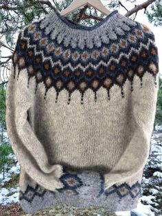 a sweater hanging on a tree branch in the snow