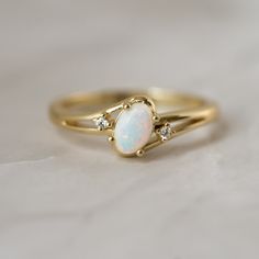 Delicate ring featuring an oval opal that sparkles so beautifully! A true beauty and must have!  - - - D E T A I L S - - -  * Made of 925 Sterling Silver * We use a THICK, DURABLE 14k Gold or Rhodium plating - for a piece that will last you years to come!  * Lab Created Opal- we use the highest grade for an authentic look * VERY HIGH QUALITY  * Nickel-free & Hypoallergenic * Available in sizes  4-12 Ring Sizer- https://www.etsy.com/listing/1240904225/ring-sizer-reusable-ring-sizer-plastic?click_key=f93d1ab266e67efb3e3db4839cb55bfeb500cb3b%3A1240904225&click_sum=4c496bae&ga_search_query=ring%2Bsizer&ref=shop_items_search_2&pro=1 Made with 100% Pure Love! ♡ Happy to answer any questions you may have! 🥰 Let's Connect! 🥰 IG: samijewels_ Oval Opal Promise Ring With Accent Stones, Oval Opal Promise Ring, Oval Cabochon Opal Wedding Ring, Dainty Oval Opal Rings, Heirloom Opal Rings With Oval Shape, Heirloom Oval Opal Ring With Accent Stones, Heirloom Opal Oval Rings, Oval Opal Rings With Accent Stones, Opal Oval Diamond Ring With Gemstone