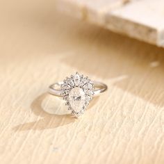 a diamond ring sitting on top of a wooden table