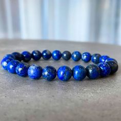 Lapis lazuli is a powerful stone for spiritual growth and enlightenment. This bracelet is designed to help you connect with the wisdom and power of lapis lazuli, and to promote your ongoing spiritual growth. The beautiful blue color of the stone is said to be associated with the divine, and wearing it can help you access your inner guidance and intuition. Holistic Blue Beaded Bracelets, Holistic Blue Beaded Bracelets For Meditation, Blue Lapis Lazuli Gemstone Beaded Bracelet, Sapphire Lapis Lazuli Bracelets With Round Beads, Spiritual Blue Beaded Bracelets For Meditation, Spiritual Blue Lapis Lazuli Beaded Bracelets, Sapphire Gemstone Beads Bracelet In Lapis Lazuli, Blue Spiritual Hand-strung Bracelets, Blue Hand-strung Spiritual Bracelets