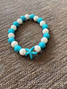 Color - Teal and Cream With Teal Starfish Charm Casual Star Jewelry For Summer, Casual Star-shaped Summer Jewelry, Casual Summer Star Shaped Jewelry, Handmade Turquoise Starfish Bracelets, Handmade White Starfish Bracelets, White Starfish Bracelet With Ocean-inspired Style, Handmade Star Bracelets For Beach, White Ocean-inspired Starfish Bracelets, White Starfish Ocean-inspired Bracelet