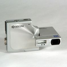 a silver camera sitting on top of a white table