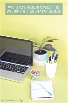 an open laptop computer sitting on top of a desk next to a cup and pen