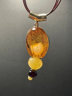 A ball of butterscotch amber looking like a fluffy rabbit tail wrapped inside a piece of 3A's super clear cognac amber formed this rare piece of jewel. The design is completed with two other butterscotch amber and one blood amber beads. Pendant height: 77.1 mm Pendant width: 26.4 mm Pendant thickness: 23.7 mm Necklace length: 450 mm with extender  Weight: 24.41 g ABOUT OUR PRODUCTS All our ambers are 100% natural, not in any way enhanced. Every item in our shop are handmade with love and happy v Luxury Amber Gold-plated Jewelry, Luxury Amber Necklaces With Gemstone Accents, Luxury Amber Necklaces Fine Jewelry, Luxury Amber Oval Necklaces, Luxury Citrine Amber Necklace, Luxury Amber Citrine Necklace, Luxury Carnelian Amber Necklace, Luxury Amber Necklace For Formal Occasions, Cheap Amber Necklaces