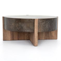 a wooden and metal coffee table sitting on top of a white floor