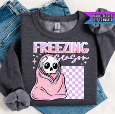 a black shirt with a skull wearing a pink scarf on it and the words freezing sugar written in white