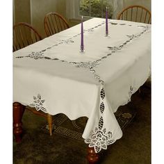 a white table with two candles on it