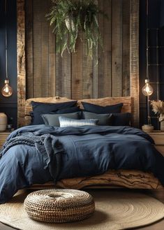 a bed with blue linens and pillows in a rustic style bedroom, surrounded by wooden planks